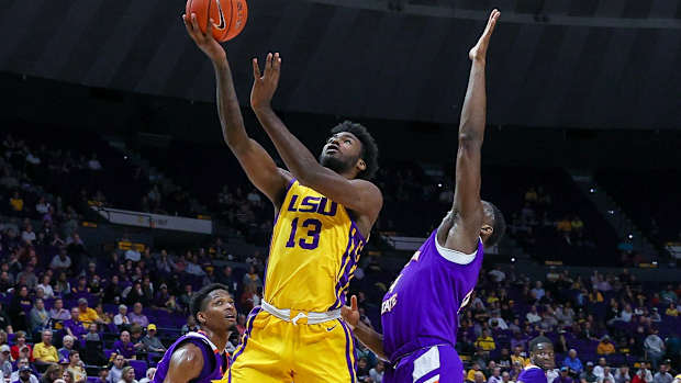 Dec 14, 2021; Baton Rouge, Louisiana, USA; LSU Tigers forward Tari Eason (13) drives to the basket against Northwestern State Demons center Kendal Coleman (4) during the first half at Pete Maravich Assembly Center. Mandatory Credit: Stephen Lew-USA TODAY Sports